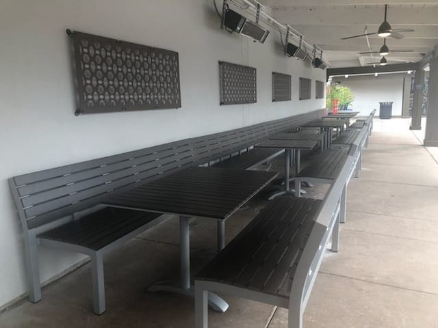 Semi-private outdoor dining area with modern tables for casual gatherings in San Jose.