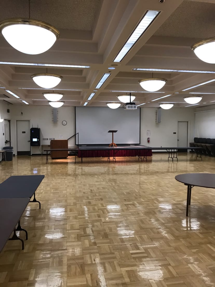 Versatile conference room with stage and flexible seating for events at De Anza College.