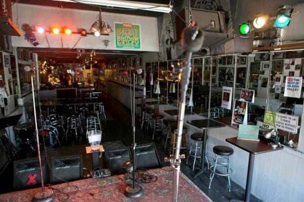 Main Lounge in JJ's Lounge, featuring a stage for live performances and gatherings.