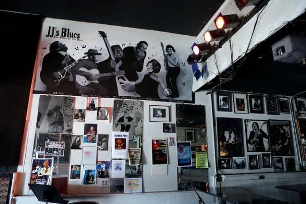 Vibrant JJ's Lounge with musician mural, perfect for live music events and parties.