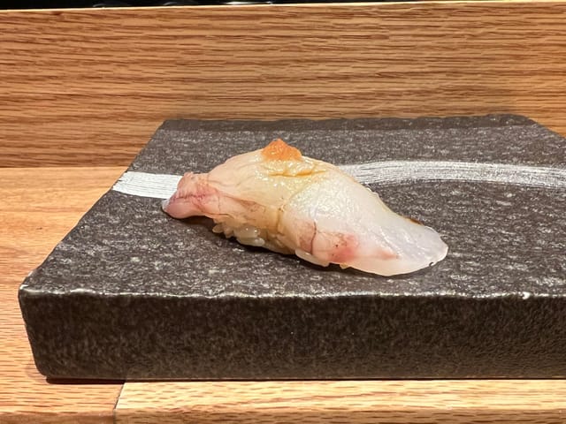 Elegant sushi on stone plate, perfect for upscale events and networking.