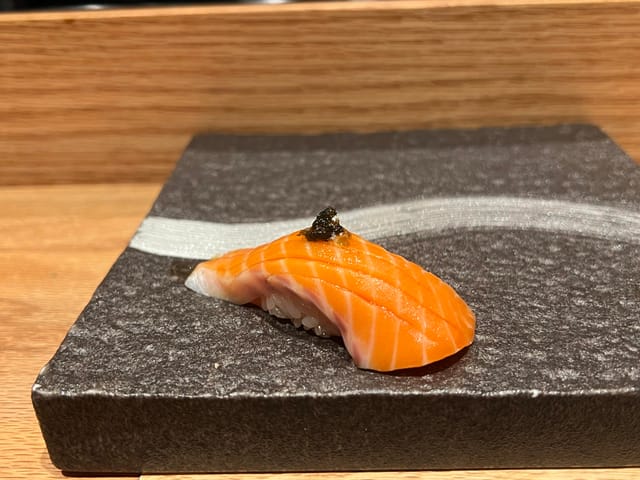 Elegant sushi presentation on a stone plate for upscale culinary events.
