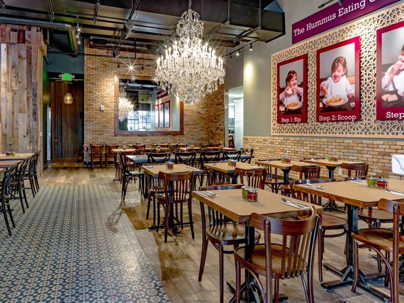 Stylish Oren's Hummus restaurant with warm lighting, ideal for events and gatherings.