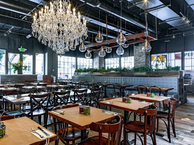 Stylish Oren's Hummus restaurant with elegant chandelier, perfect for events and gatherings.