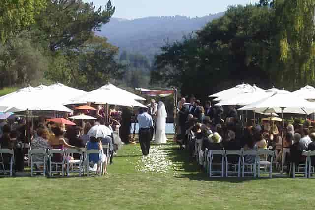 Outdoor wedding ceremony with floral accents and scenic water backdrop at The Jesse Charles Band.