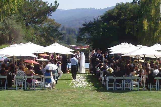 Outdoor wedding ceremony with floral accents and scenic water backdrop at The Jesse Charles Band.