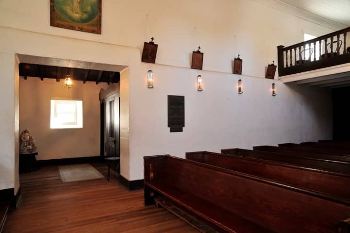 Adobe Chapel venue with rustic wooden pews, ideal for intimate ceremonies and gatherings.