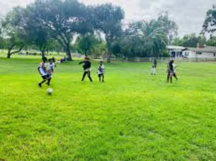 Outdoor soccer practice at Eritrean Community Services San Diego, promoting team-building events.