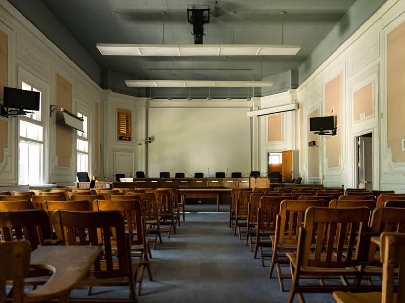 Spacious meeting room with wooden chairs, ideal for conferences and workshops.