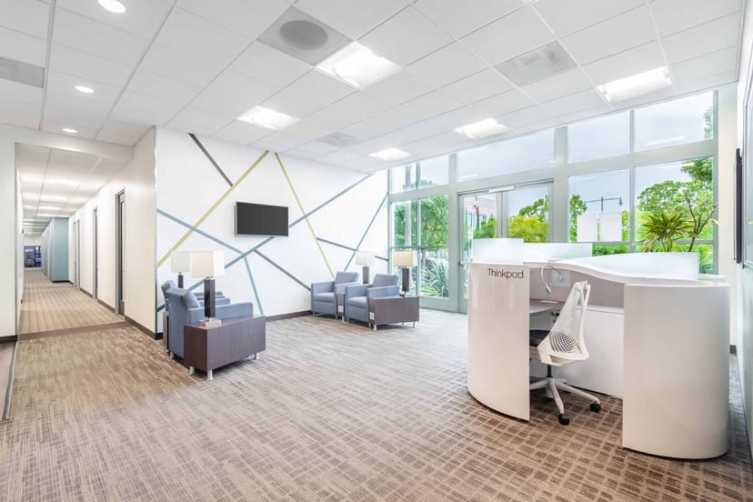 Modern coworking reception area with natural light for meetings and networking events.