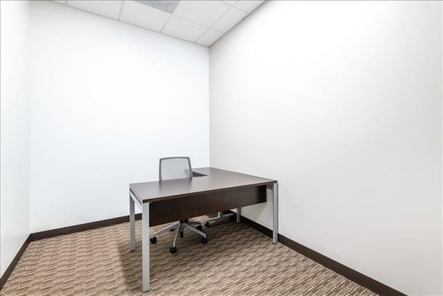 Minimalist meeting space with desk and chair at 2305 Historic Decatur Road.