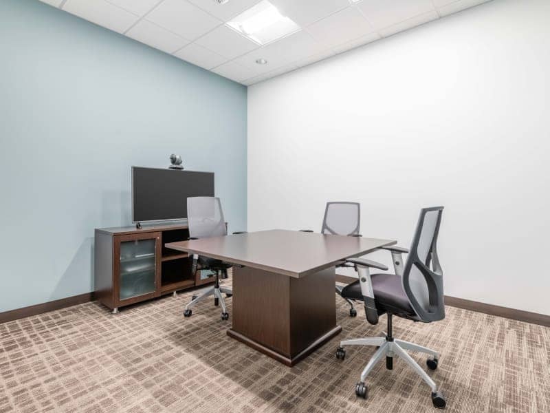 Modern minimalist meeting room with ergonomic chairs for productive discussions.