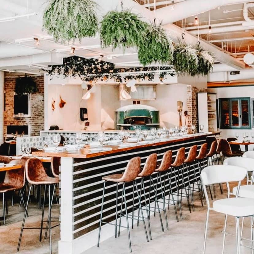 Stylish Siamo Napoli restaurant interior with bar, perfect for events and gatherings.