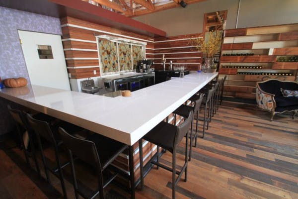 Modern event space with sleek bar and warm wooden accents for networking gatherings.