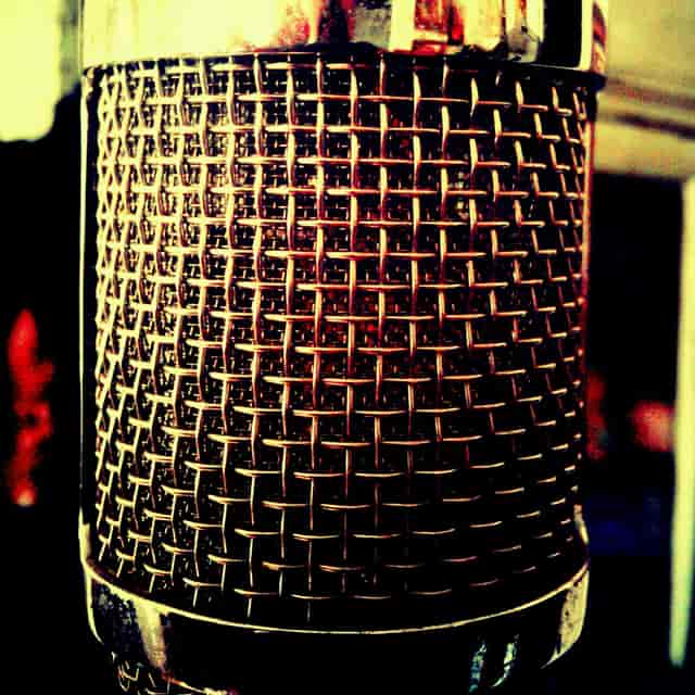 Close-up of textured microphone in CHAOS Recorders studio for clear audio events.