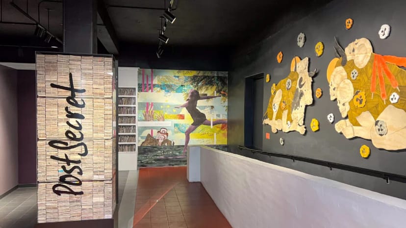 PostSecret exhibit at Museum of Us, featuring vibrant artwork for creative events.