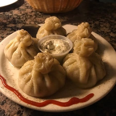 Dumplings with dipping sauce at Bar in Pomegranate for events and catering.