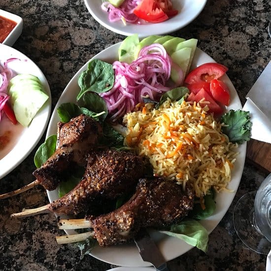 Plated spiced lamb chops at Pomegranate restaurant for events and catering.