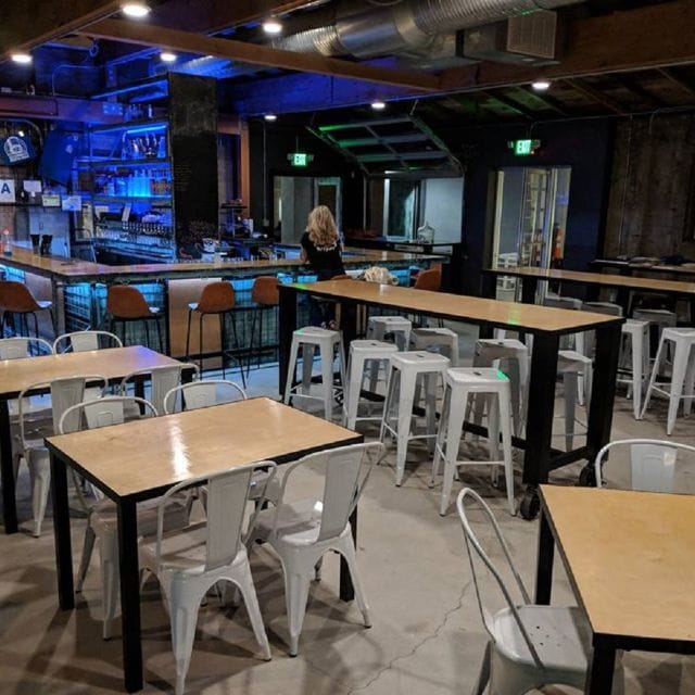 Modern bar setup in versatile event space for networking and casual gatherings.