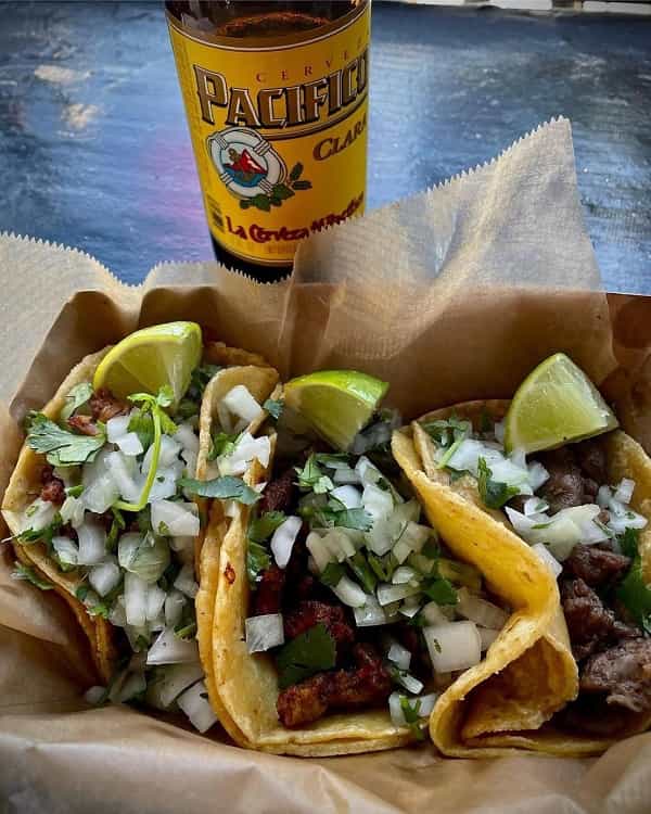 Vibrant tacos with onions and cilantro at Gringas Tacos for events and catering.
