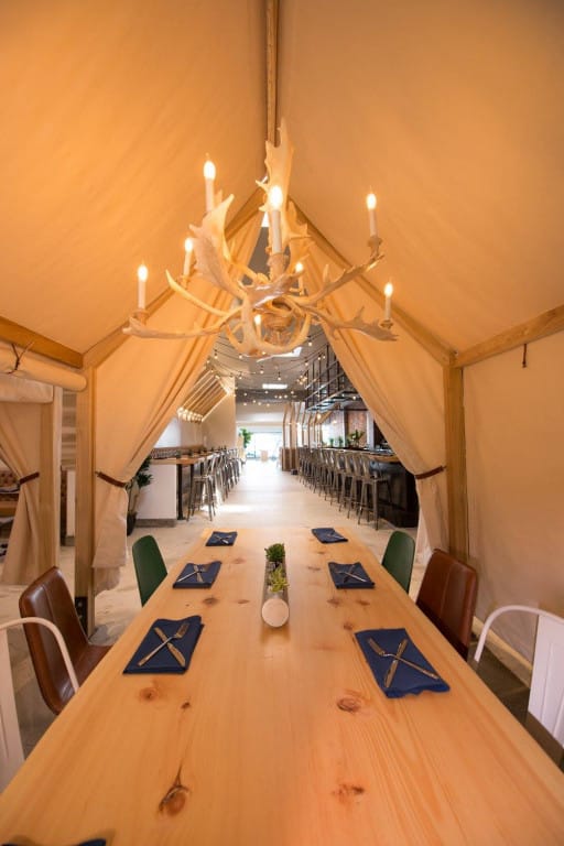 Stylish event space at One Door North with tent-like structure and elegant decor.