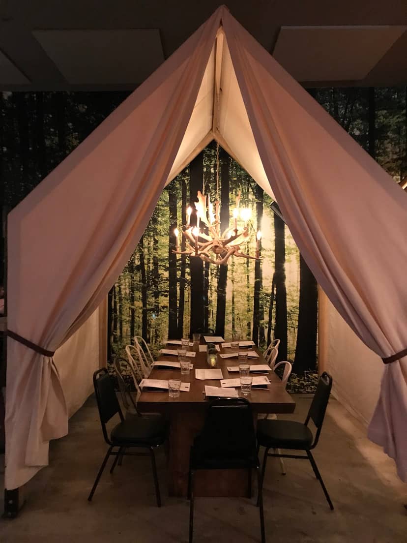 Intimate restaurant dining space with forest theme, perfect for exclusive events and gatherings.