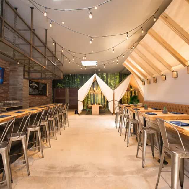 Intimate event space at One Door North with warm lighting, ideal for workshops and gatherings.