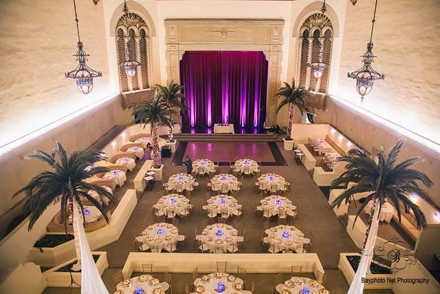 Corinthian Grand Ballroom with elegant tables and vibrant purple accents for upscale events.