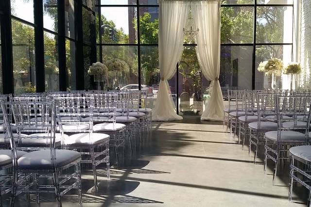 Elegant wedding venue with clear acrylic chairs and floral decor at Morton's The Steakhouse.