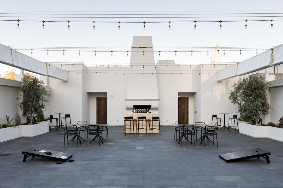 Versatile outdoor event space with sleek furniture and ambient lighting for gatherings.