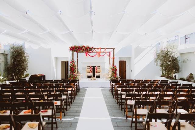 Elegant wedding ceremony setup with floral arch in Blanco Urban Venue's Mezzanine.