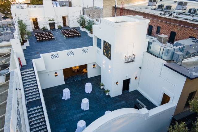 Stylish rooftop venue with elegant tables, perfect for weddings and corporate events.