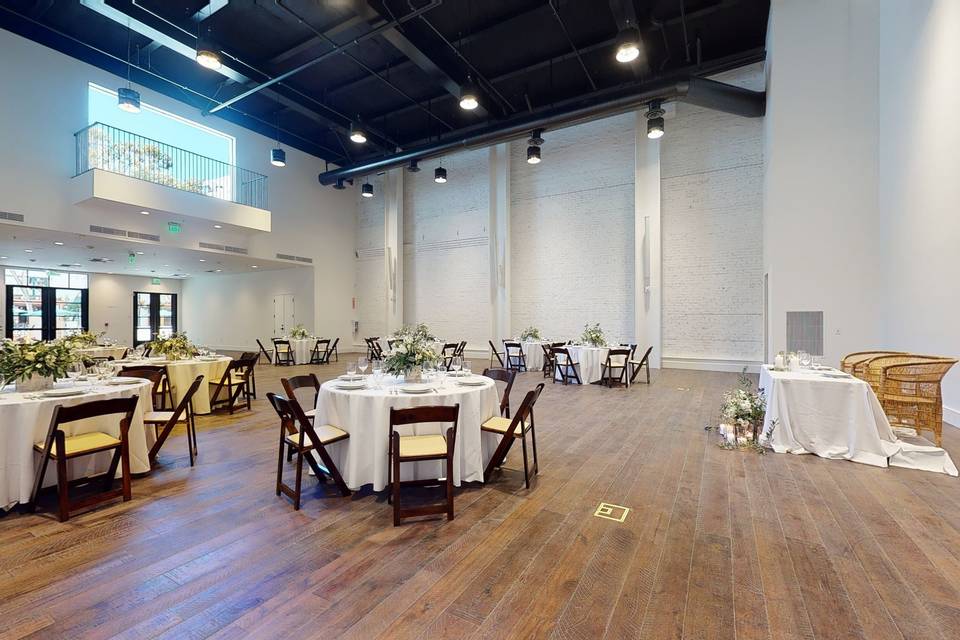 Elegant event space with round tables, ideal for weddings and corporate events.