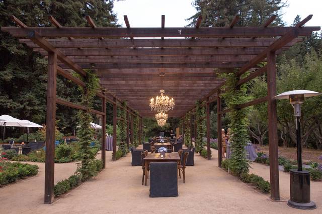 Apple Knoll outdoor event space with rustic pergola, perfect for weddings and retreats.