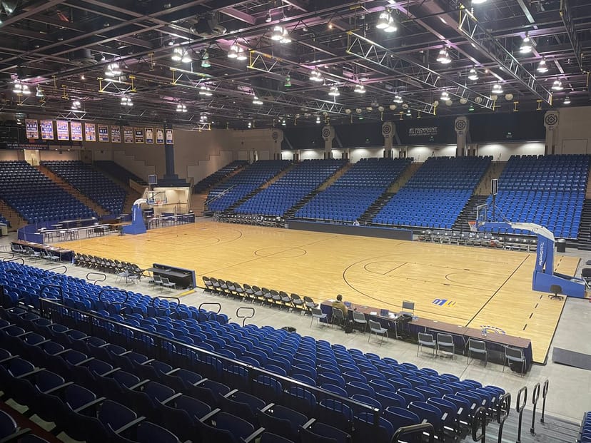 Event Center Arena with polished wooden floor, ideal for conferences and concerts.