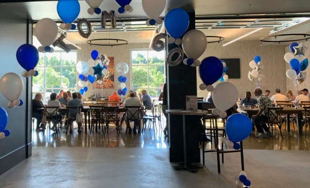 Vibrant event space with blue and white balloons for celebrations at Silver Creek Sportsplex.