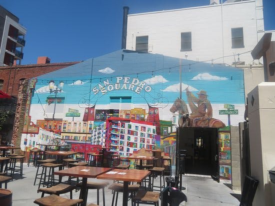 Vibrant outdoor venue with mural, ideal for casual gatherings and networking events.