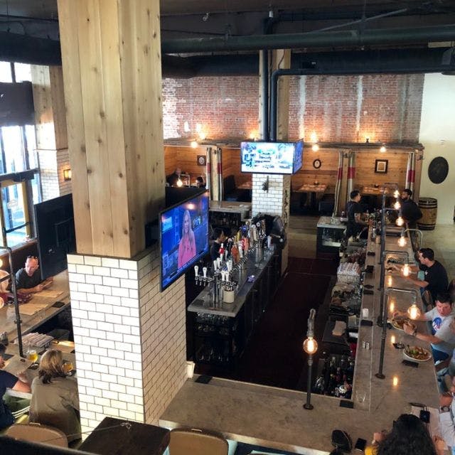 Outdoor patio at The Farmers Union with exposed brick, perfect for casual events and networking.