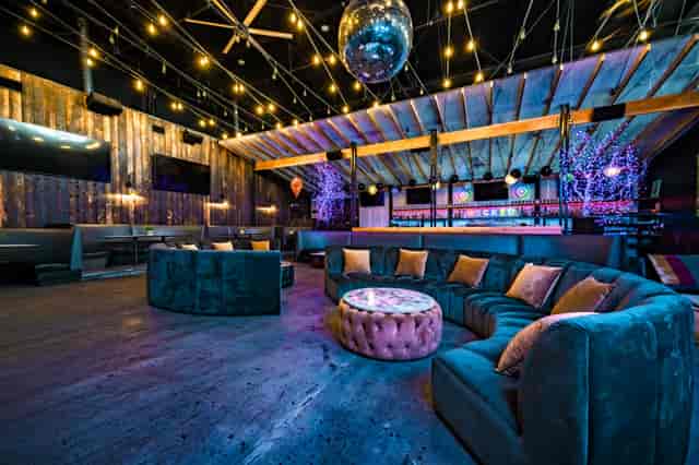 Stylish event space with plush seating and disco ball for cocktail receptions.