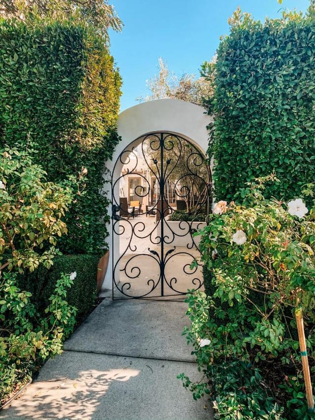 Elegant wrought-iron gate in Hotel Marisol Coronado's private garden courtyard for events.