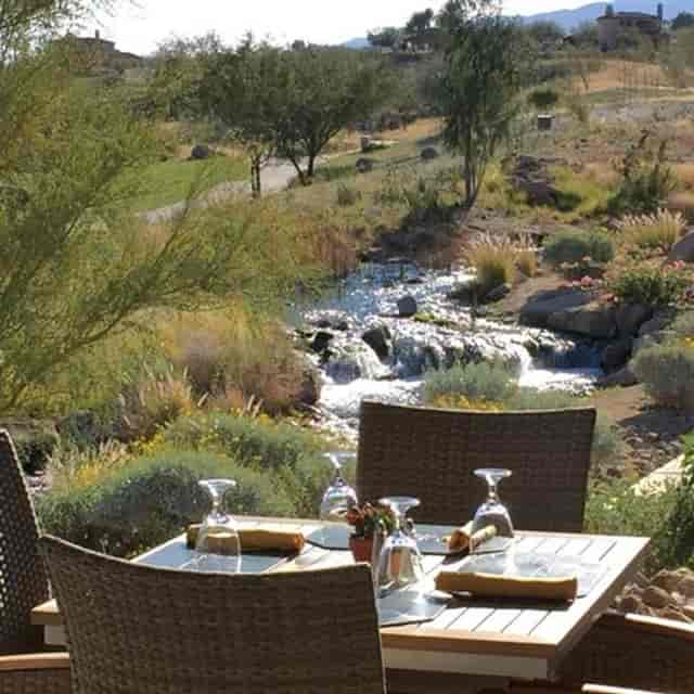 Outdoor patio at JC Bruno Restaurant with elegant table setup for events and meetings.