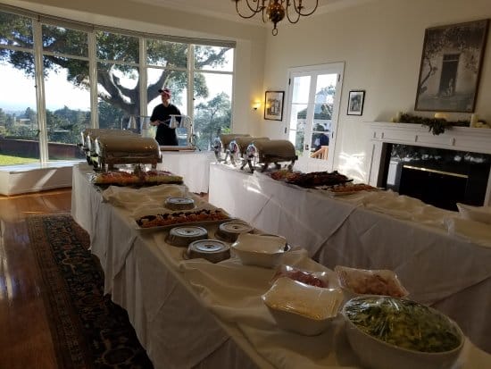 Elegant buffet setup at The Hollins House for events, featuring chafing dishes and natural light.