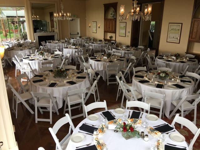 Elegant bar setup with round tables for weddings and corporate events.
