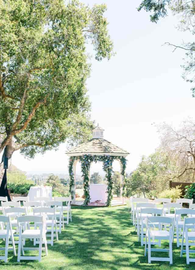 Wedding gazebo at The Hollins House, adorned with greenery for elegant outdoor ceremonies.