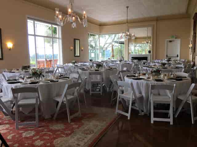 Elegant dining room with white linens, perfect for formal events and celebrations.