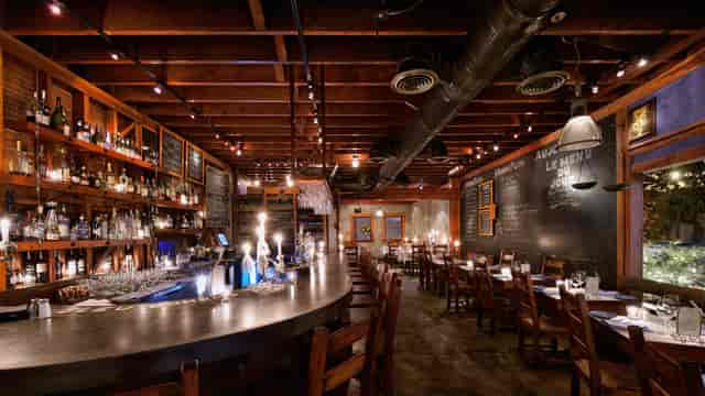 Stylish bar in Bleu Bohème, warm lighting, perfect for private events and gatherings.