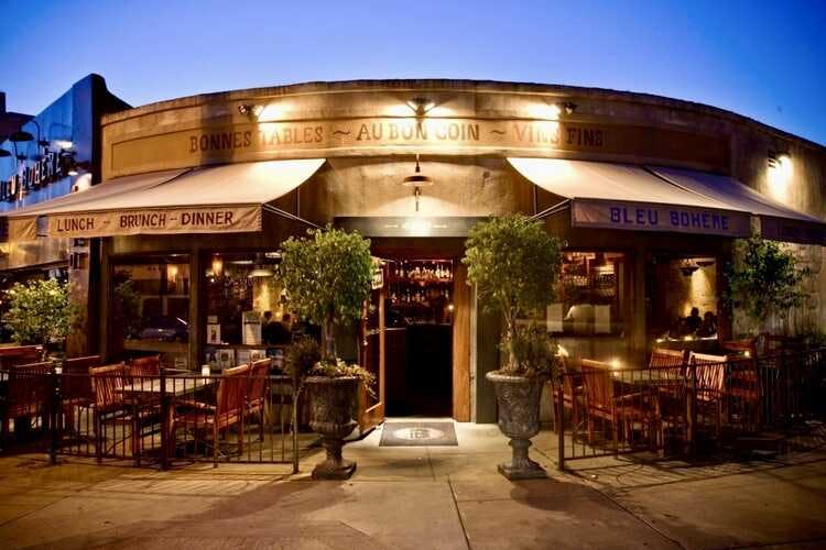 Charming Bleu Bohème restaurant exterior with outdoor seating for intimate events.
