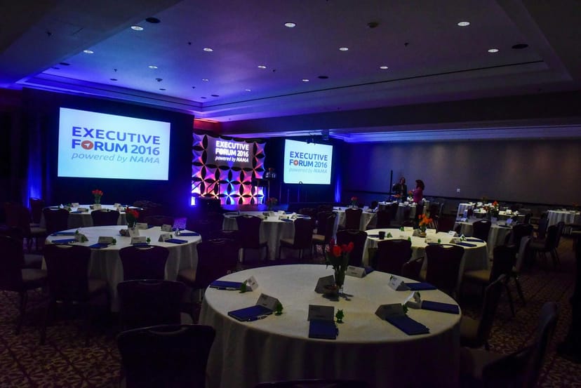Elegant event space for Executive Forum 2016 with blue and white decor, ideal for networking.