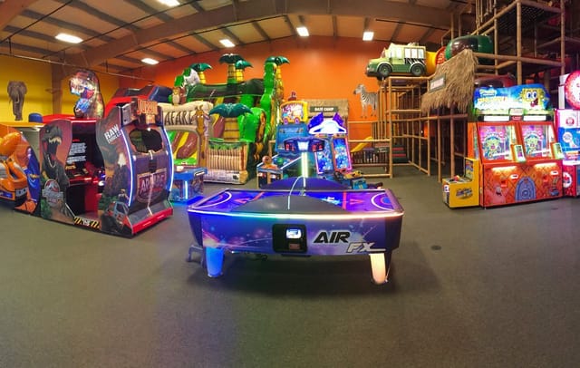 Vibrant arcade games and air hockey at Safari Adventure, perfect for team-building events.
