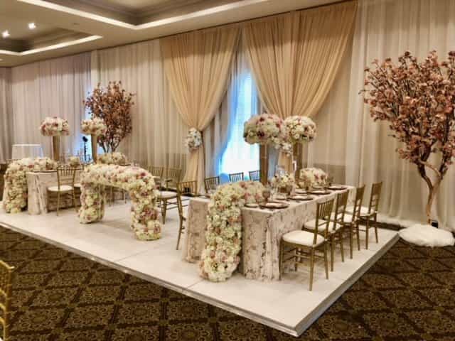 Elegant banquet hall with floral decor, ideal for weddings and upscale events.